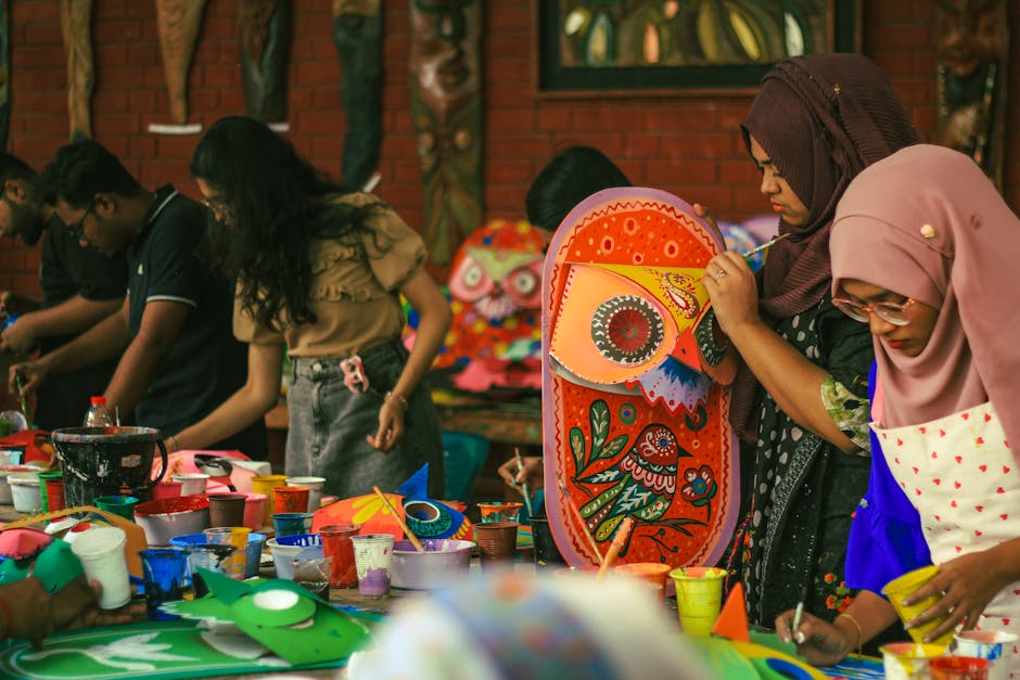 Workshop table with documents, photos, and notebooks.